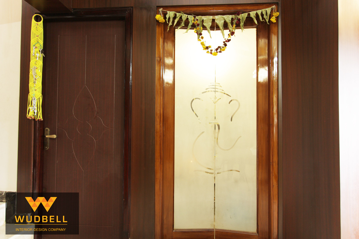 Pooja unit with veneer finish and Ganesh god design frosted glass door.