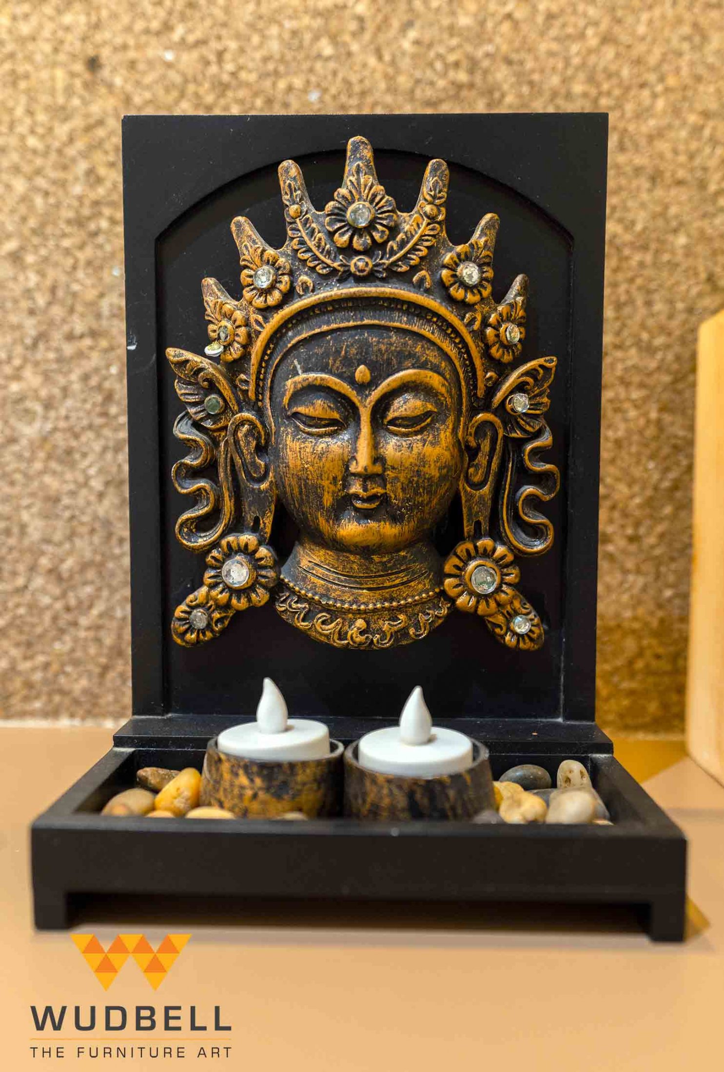The Buddha sculpture with calming pebbles and artificial diyas